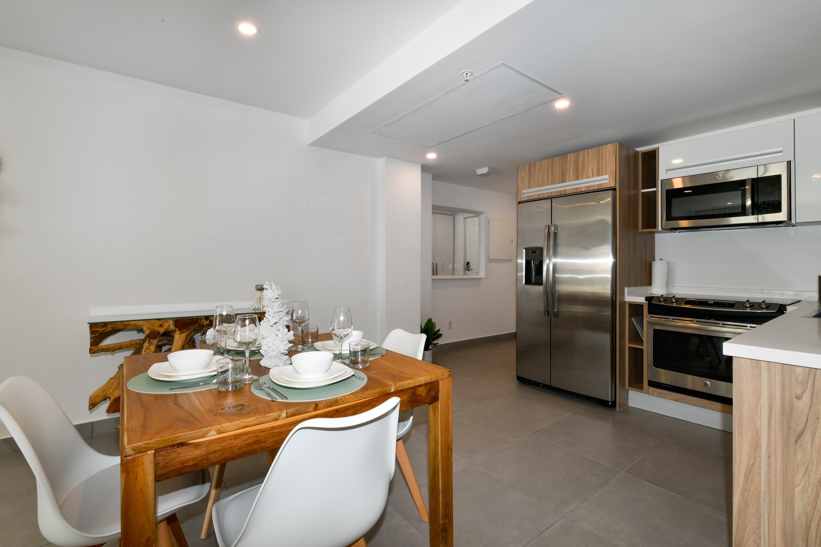 Your spacious dining and kitchen area combines modern appliances with warm wood tones, perfect for preparing and sharing meals together during your stay.