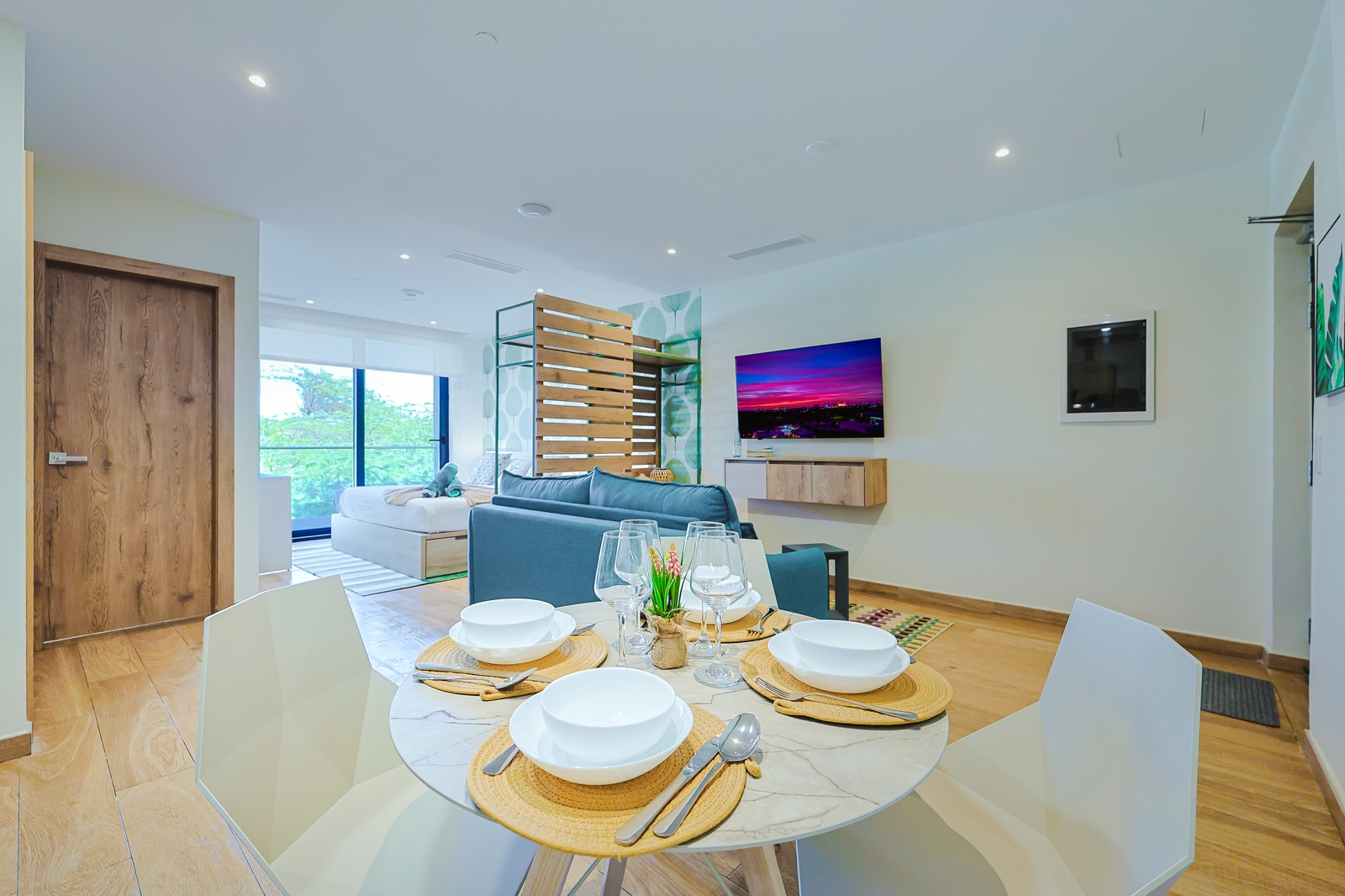 Picture yourself dining here—warm wood tones, modern elegance, and the open layout invites you to relax. The living area beyond feels perfectly connected, ready for your next meal or conversation.