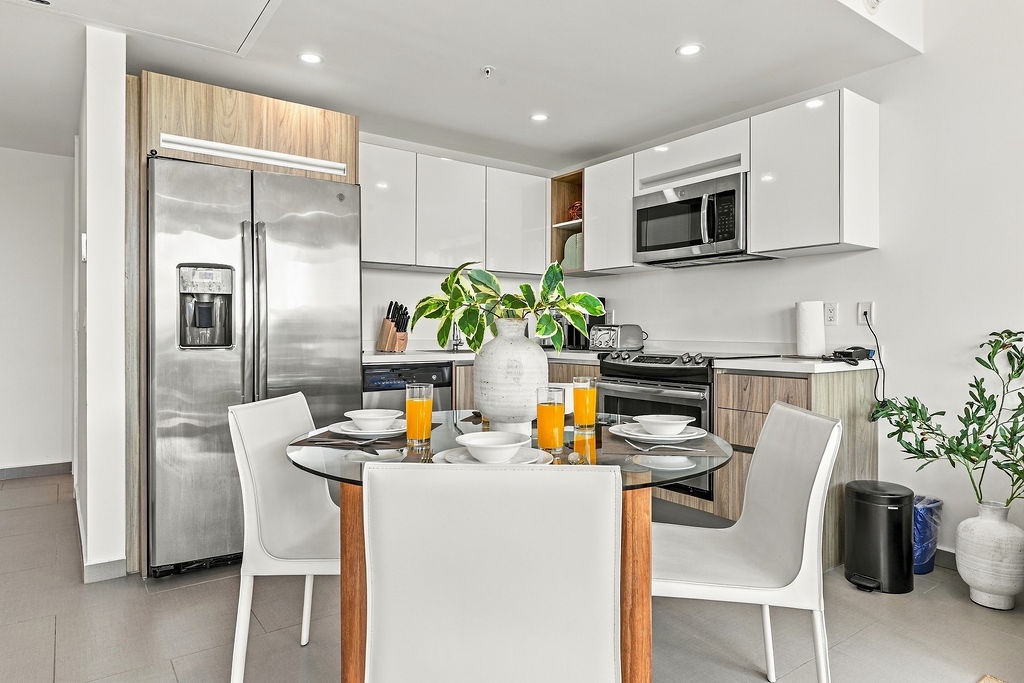 Your modern kitchen is ready for anything—stainless steel appliances, plenty of counter space, and a bright breakfast table where mornings start with fresh juice and easy conversation.