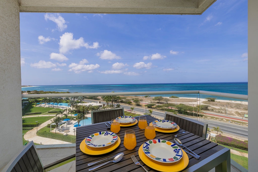 Savor morning juice at your private balcony table while taking in breathtaking ocean views stretching to the horizon—a perfect start to every vacation day.
