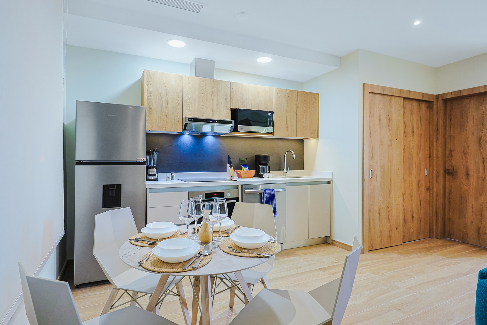 Picture yourself preparing meals in this bright, modern kitchen with sleek cabinetry and stainless-steel appliances. Gather around the stylish dining table for shared meals and laughter, creating memories in your home away from home.