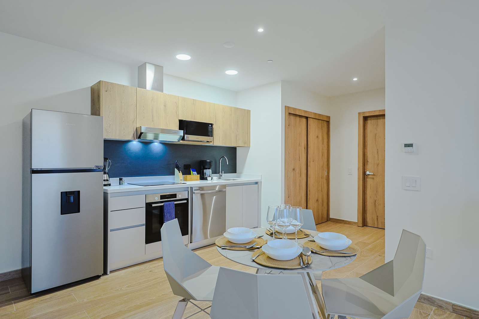 Your modern kitchen and dining area awaits with sleek appliances and a welcoming table set for meals, where you can savor home-cooked favorites in style.