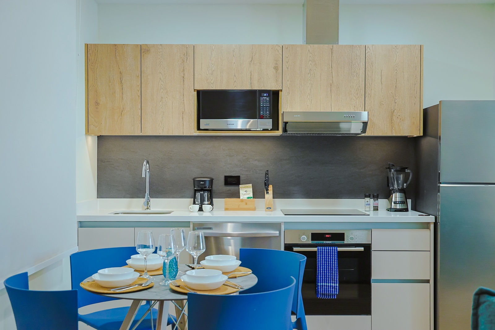Your modern kitchen is fully equipped with everything you need, from a sleek microwave and coffee maker to a stocked dining table ready for meals with loved ones.