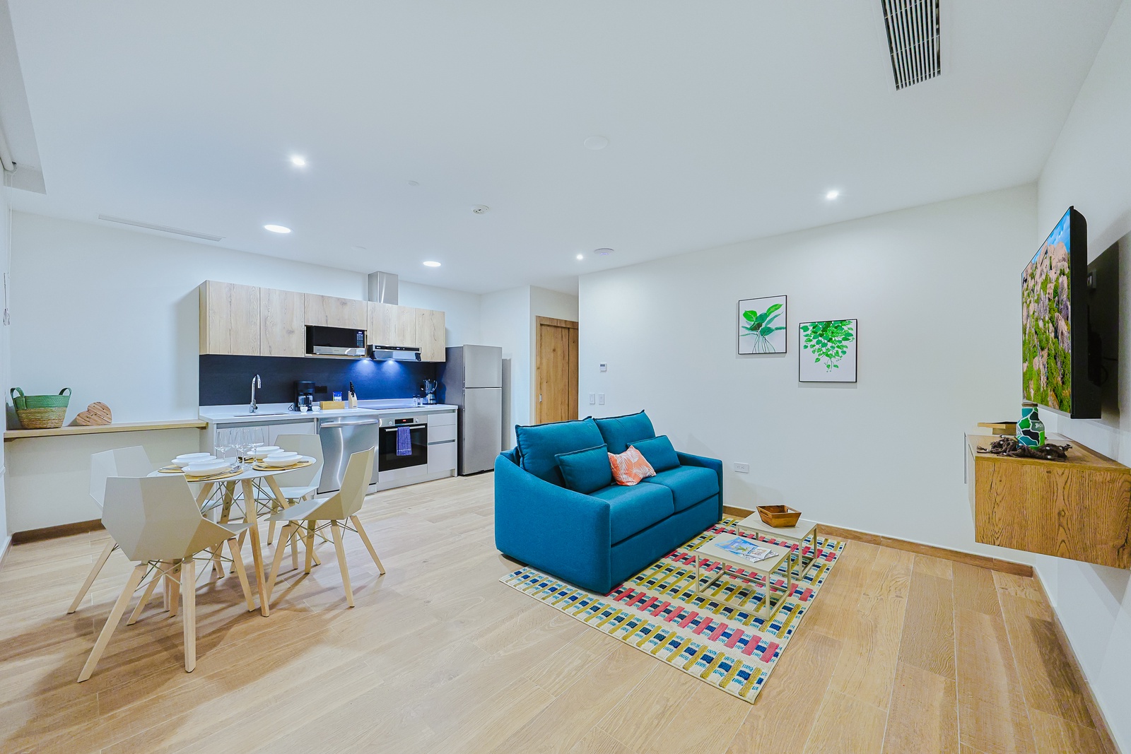 Bright, open-plan living where you'll feel right at home—modern kitchen ready for your morning coffee, a welcoming dining spot, and a vibrant seating area perfect for unwinding after a day of exploring.