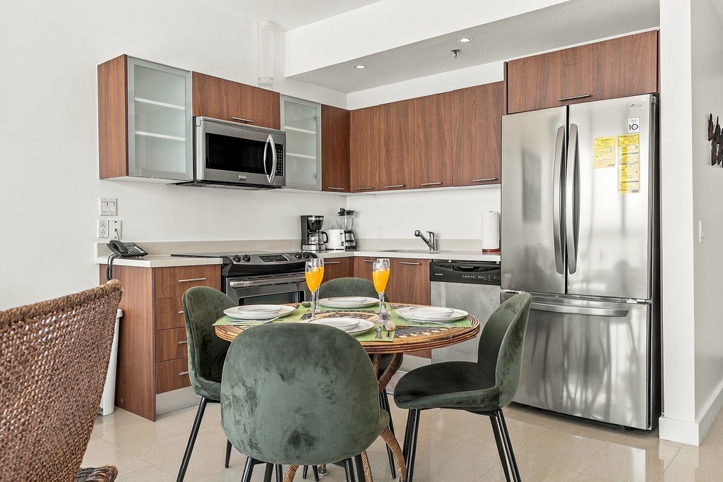 Step into your modern kitchen, where sleek stainless steel appliances meet warm wood cabinetry. Imagine starting your morning at the cozy dining nook, savoring fresh juice and planning your day's adventures in this inviting space.