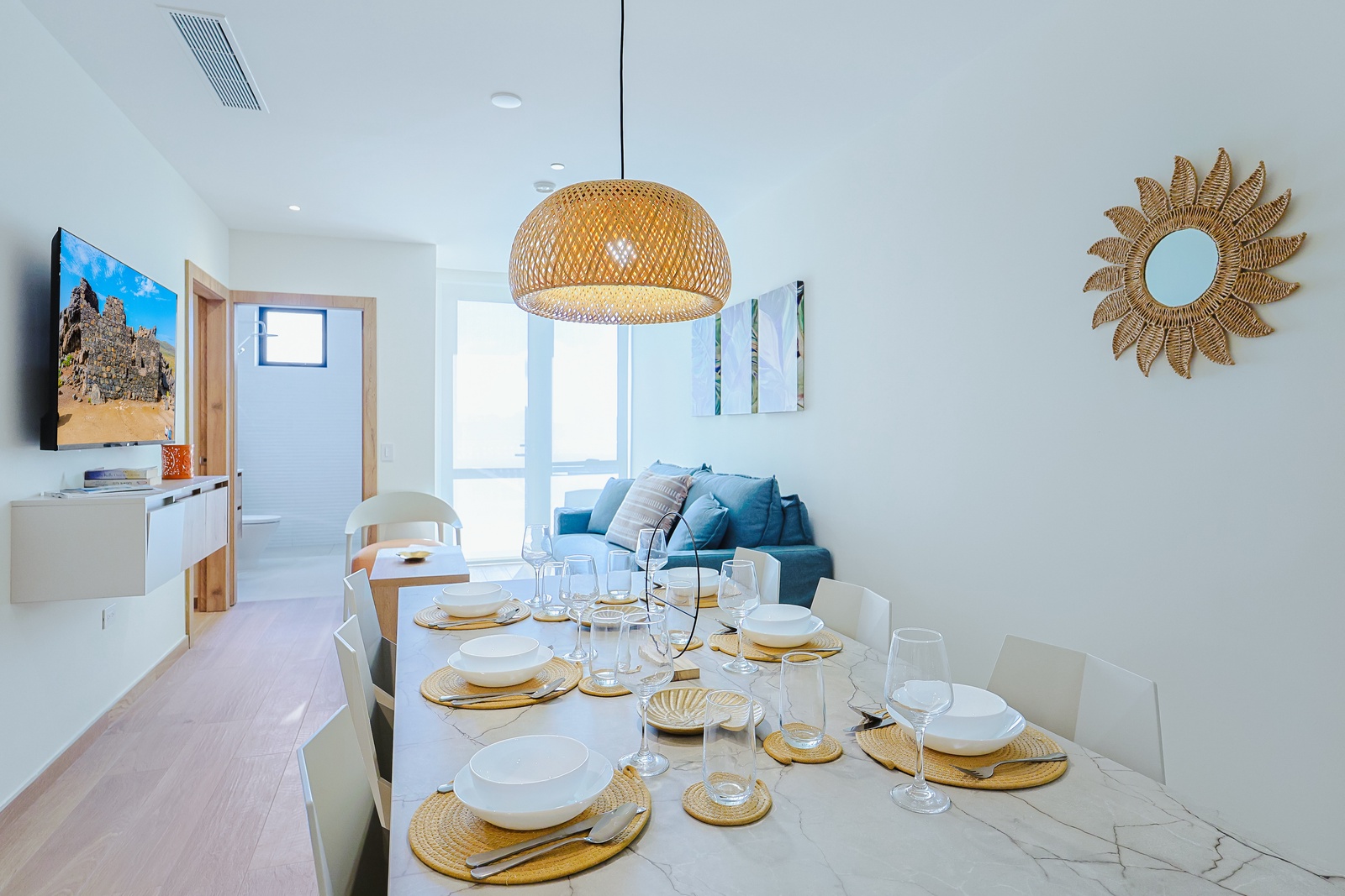 Gather with your loved ones at this beautifully set dining table, where coastal-inspired décor and plenty of natural light create an inviting space for memorable meals together.