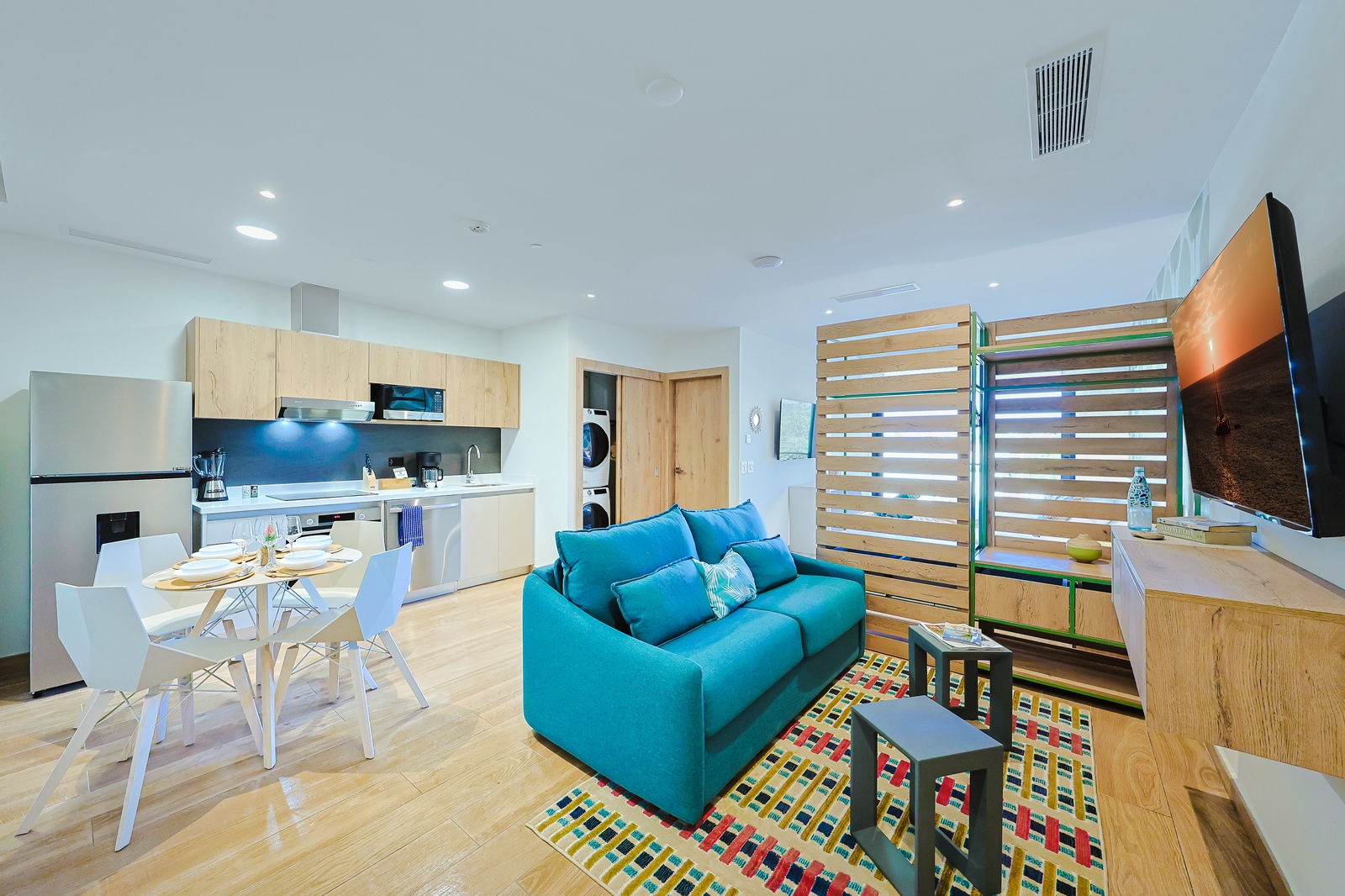 Picture yourself here in this bright, open-concept space where you can cook, dine, and relax—all in one beautifully designed room. A stylish hideaway blends modern comfort with coastal vibes.