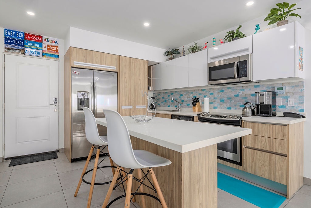 Your fully equipped kitchen welcomes you with coastal-inspired tile and stainless-steel appliances—ready for everything from morning coffee to family meals.