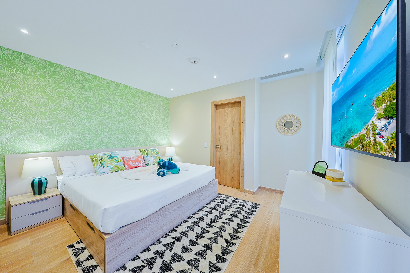Unwind in your bright, tropical-inspired bedroom with coastal touches and crisp linens that promise a restful night's sleep.