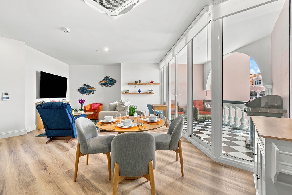 Settle into your bright, open-plan living and dining space where modern comfort meets vibrant style. Large glass doors flood the room with natural light and open onto your private balcony—perfect for morning coffee or evening relaxation.