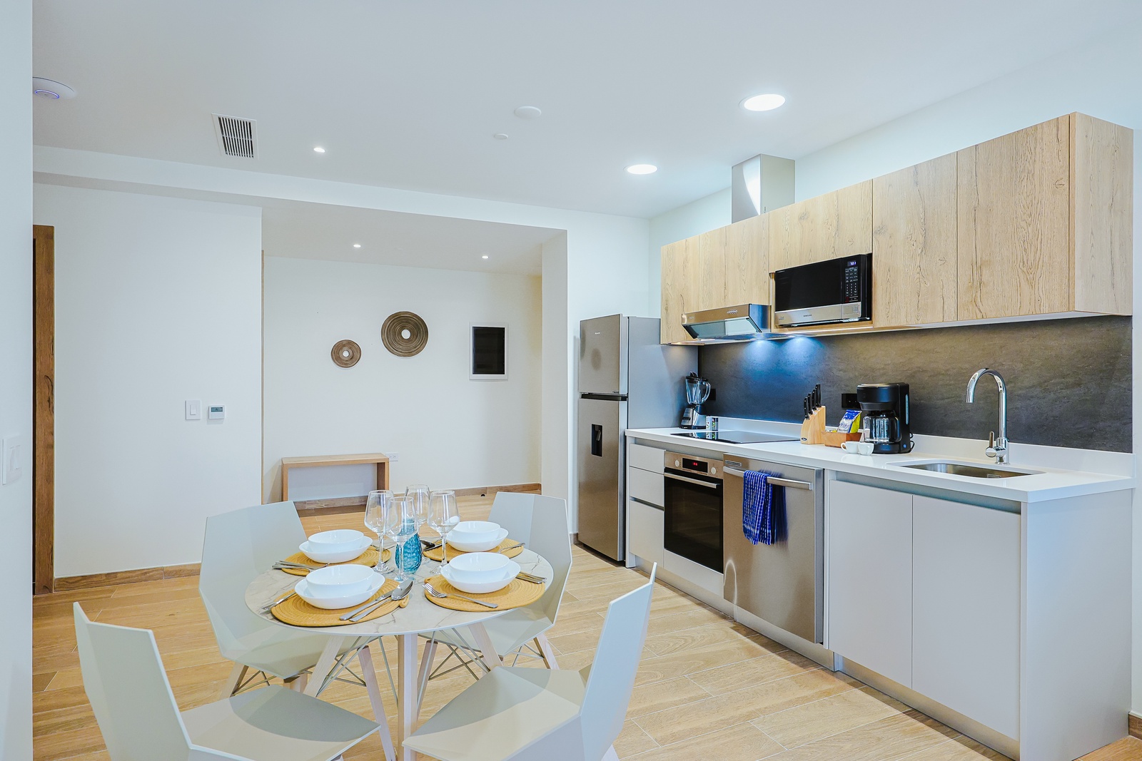 Step into your well-appointed kitchen and dining area, where sleek modern appliances and ample counter space make meal prep a breeze. Gather around the stylish dining table to enjoy home-cooked meals together in this bright, inviting space.