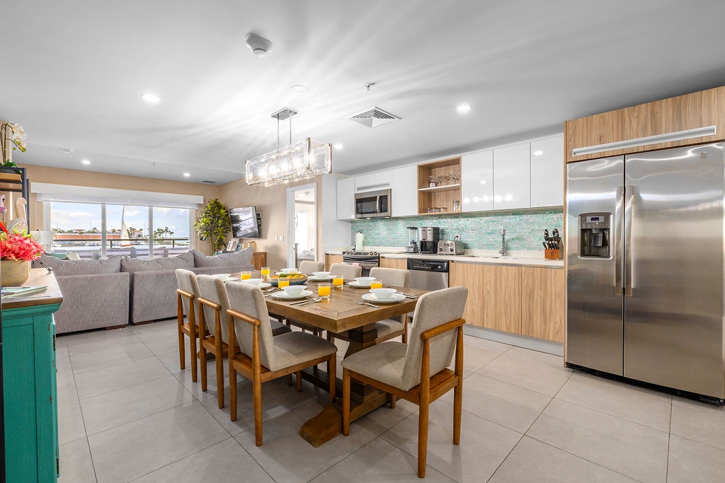 Gather around this inviting dining table with room for everyone, or relax in the cozy living area while enjoying your fully equipped modern kitchen with sleek appliances.