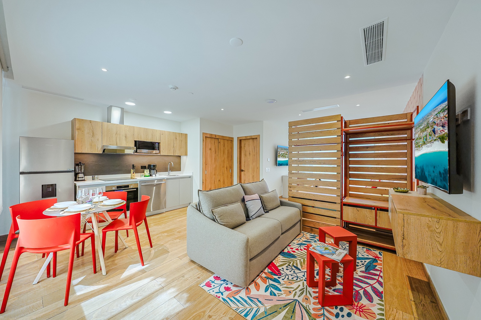 Your bright, open-plan space blends living, dining, and cooking seamlessly, with warm wood tones and playful pops of color welcoming you home after each adventure.