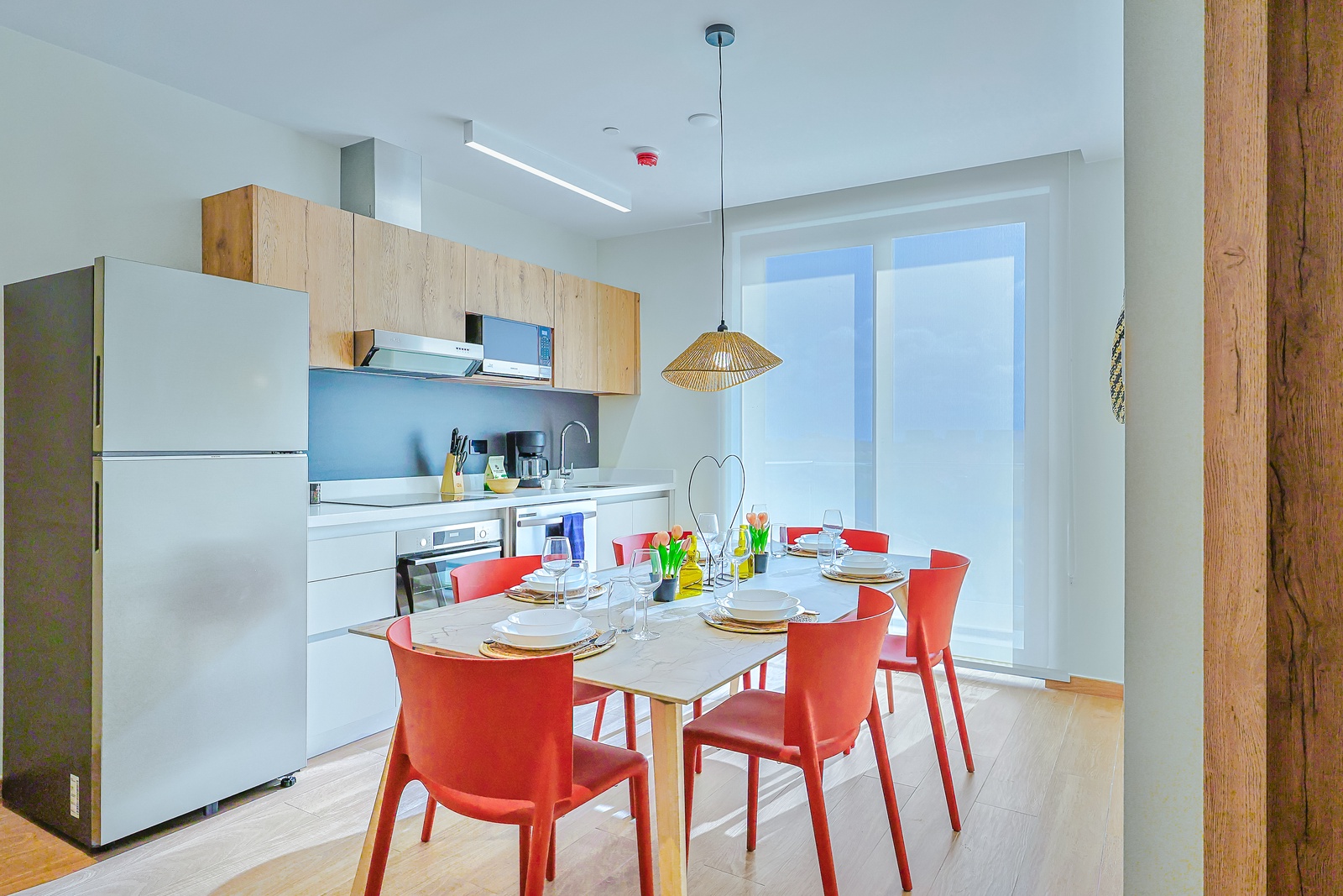 Gather around this bright, modern dining table in your fully equipped kitchen—perfect for sharing meals and making memories together during your stay.