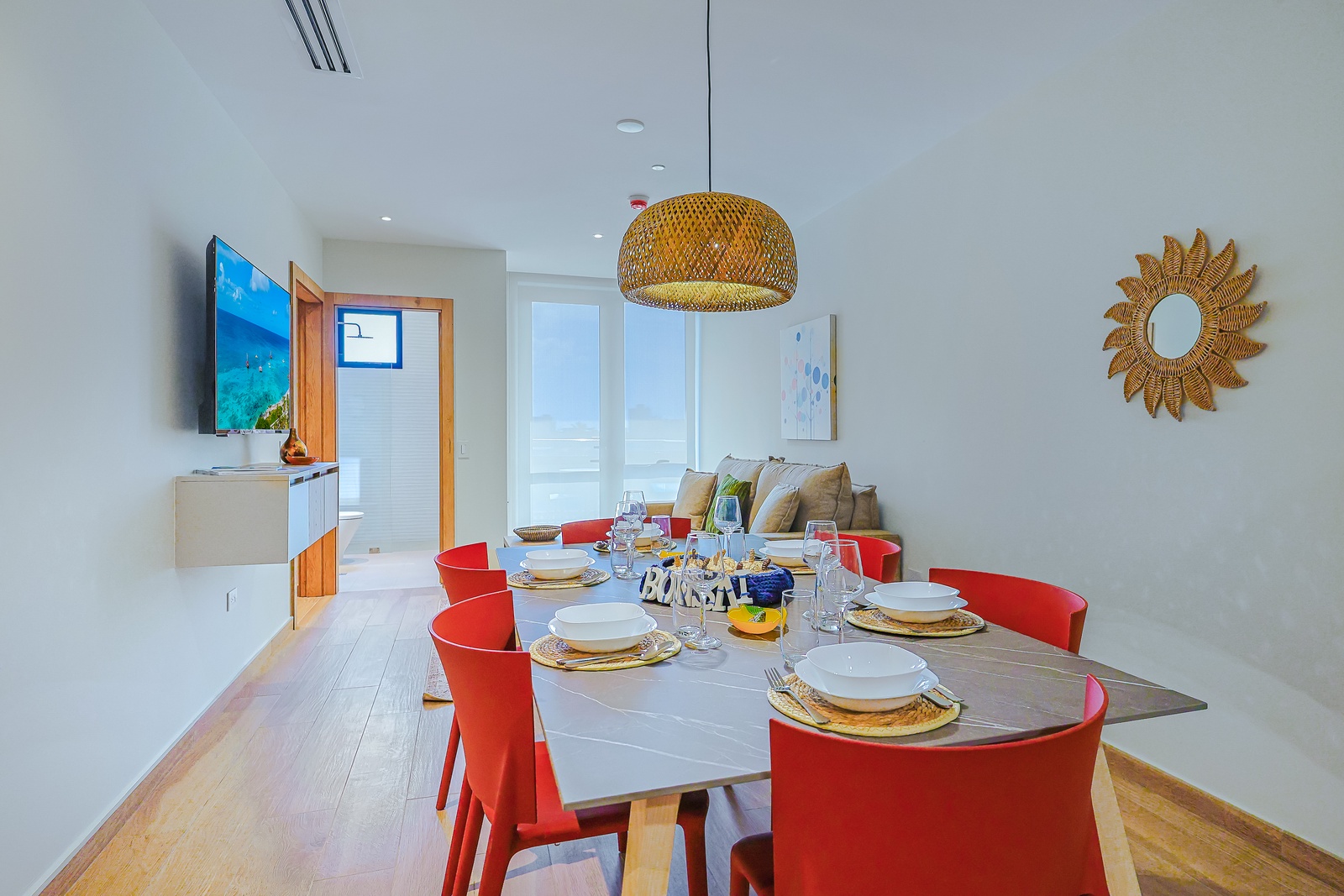 Gather around your spacious dining table, thoughtfully illuminated by warm lighting, creating the perfect setting for shared meals and memorable conversations.