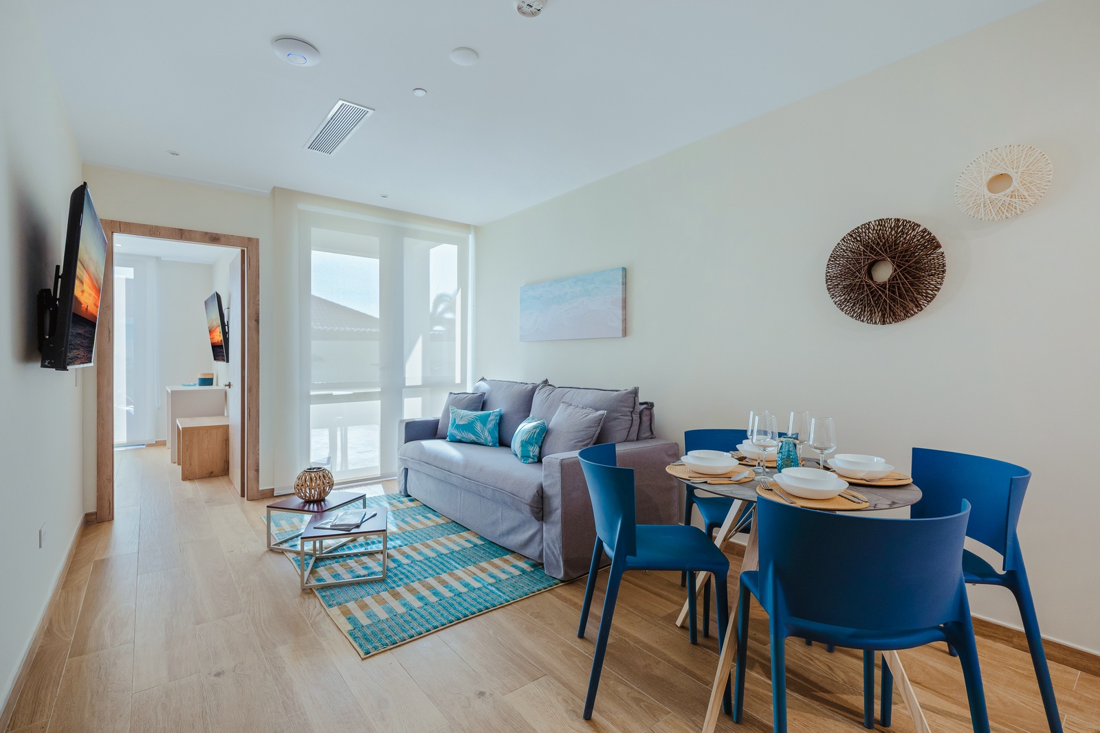 Your bright, open living and dining area awaits—a cozy sofa, stylish dining for four, and coastal-inspired decor create a relaxing retreat for unwinding together.