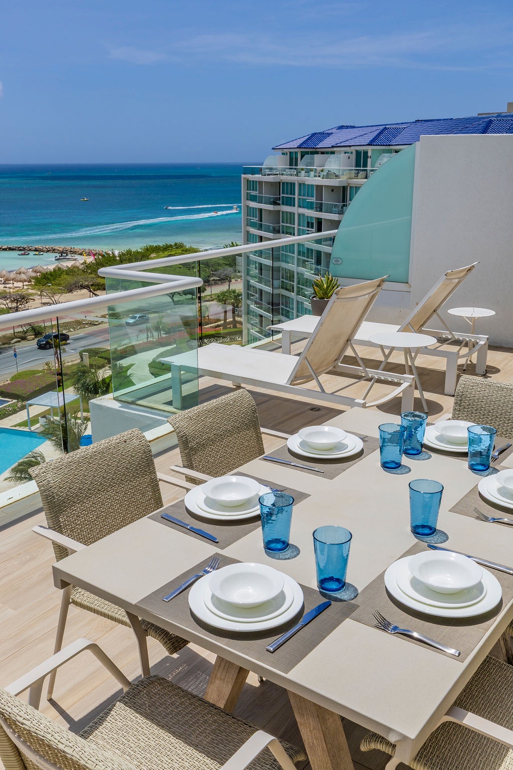Imagine savoring fresh meals at your private oceanfront dining table, feeling the warm breeze as turquoise waves shimmer below and sun loungers invite you to relax in paradise.