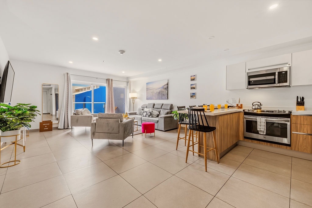 Step into a bright, modern living space where comfort meets convenience. Sink into plush seating while ocean breezes drift through your windows and whip up meals in your sleek, fully-equipped kitchen.