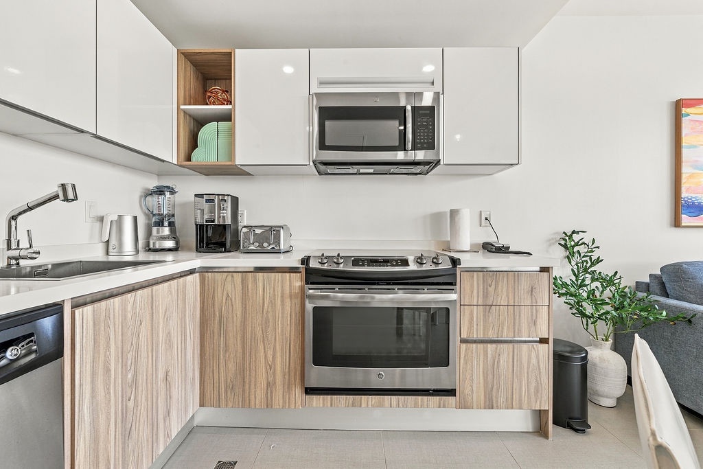 Your sleek, modern kitchen has everything you need to whip up a delicious meal. Stainless appliances, ample counter space, and stylish wood-toned cabinetry create a warm and welcoming cooking space.