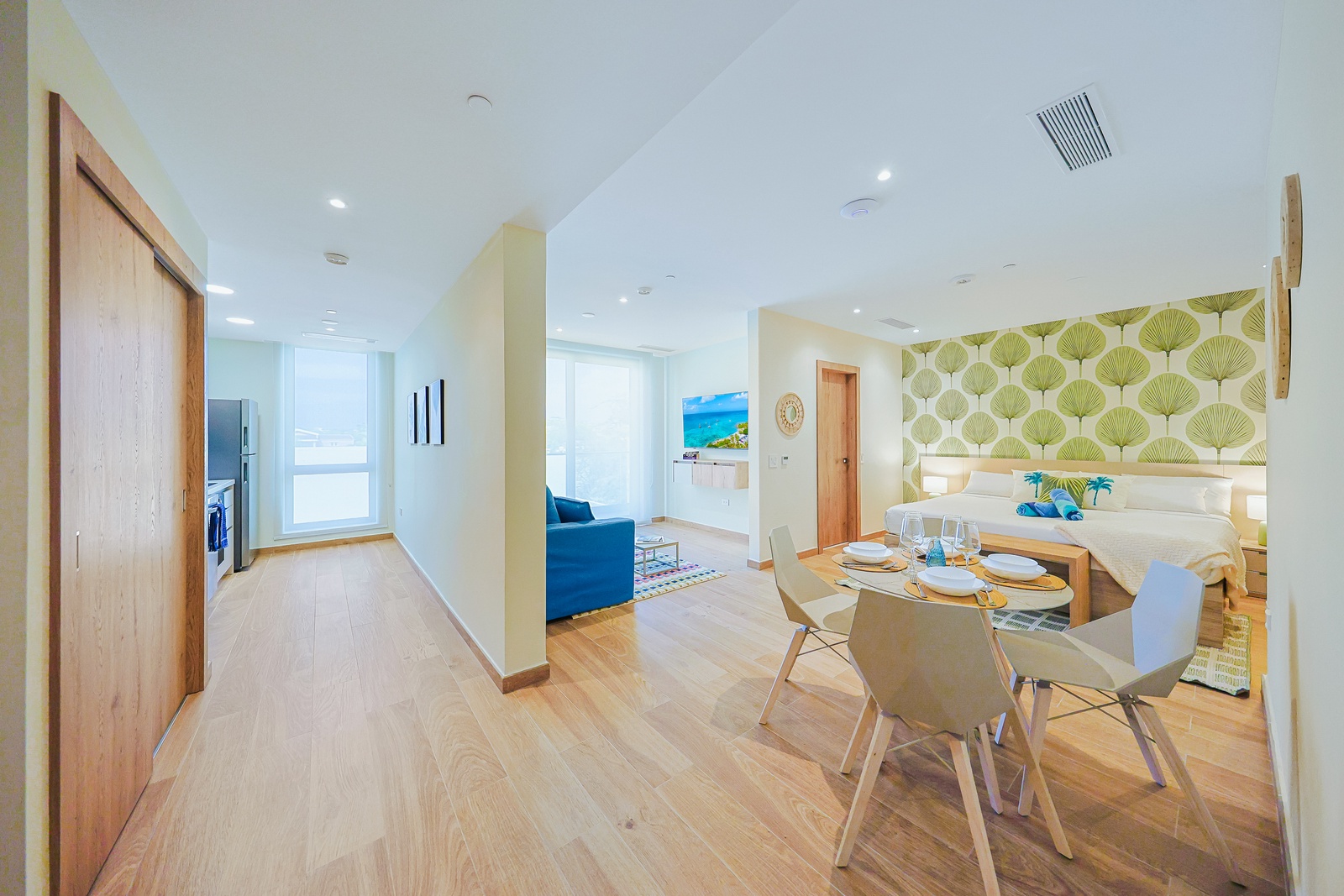 Step into a bright, modern space where thoughtful design meets comfort. Your dining table is ready for shared meals, while the inviting living area is filled with abundant natural light, creating a warm and welcoming atmosphere throughout the day.