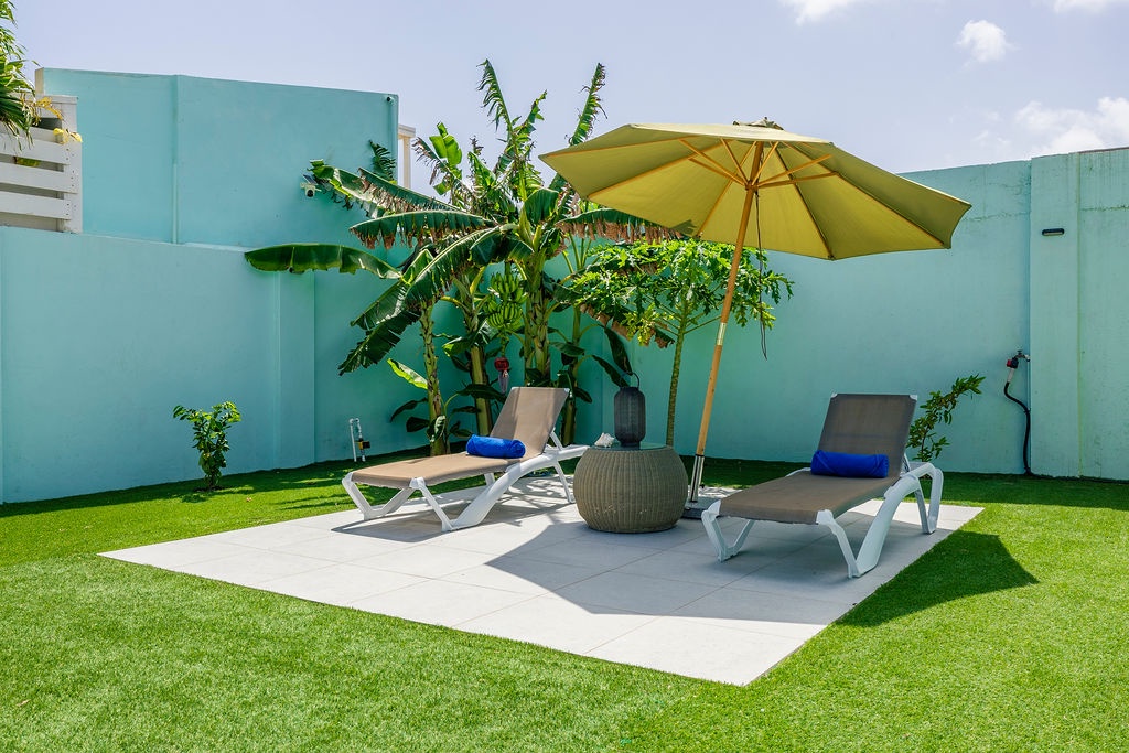 Your private sunbathing oasis awaits, complete with lush tropical greenery and shaded loungers perfect for sipping drinks and soaking up the warm sunshine.