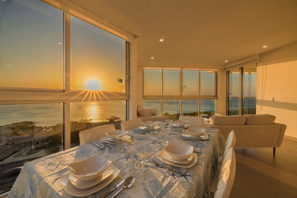 Enjoy breathtaking sunset dinners in this elegant dining space where floor-to-ceiling windows frame golden ocean views.