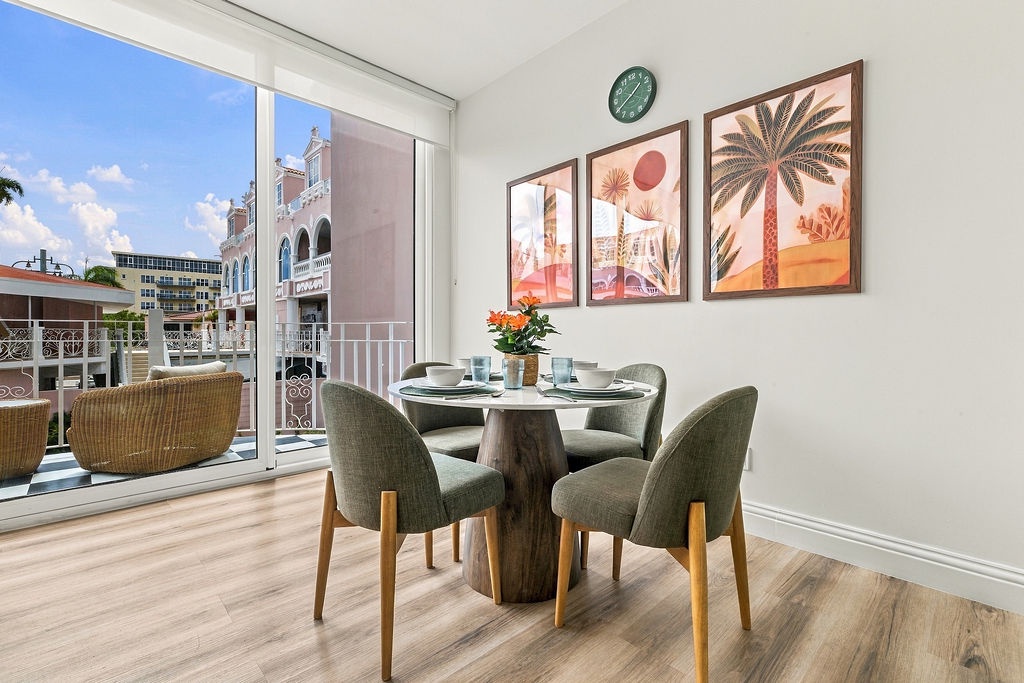 Picture yourself enjoying morning coffee at this light-filled dining table, where tropical artwork and fresh blooms create an inviting ambiance. Step onto your private balcony for fresh air and relaxation.