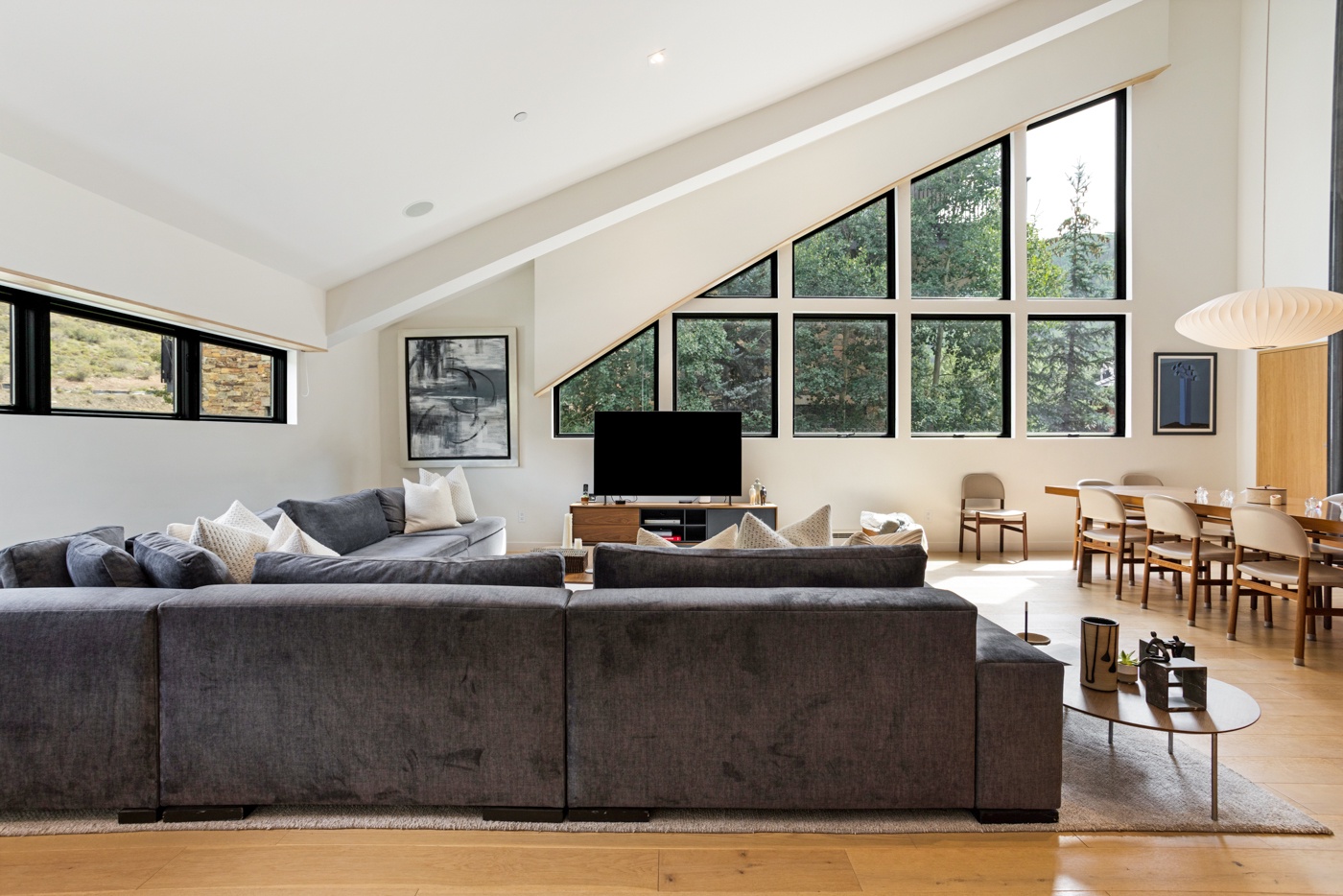 Living Room with Sectional and Forest Views