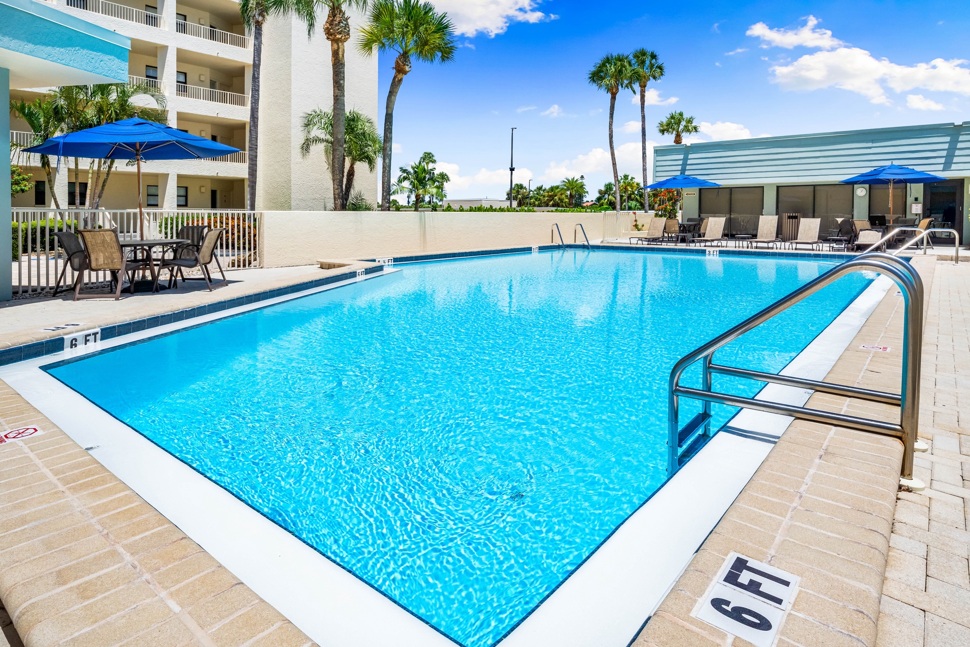 This inviting pool is surrounded by swaying palms and comfortable seating—perfect for your afternoon dip or lazy poolside lounging under sunny skies.