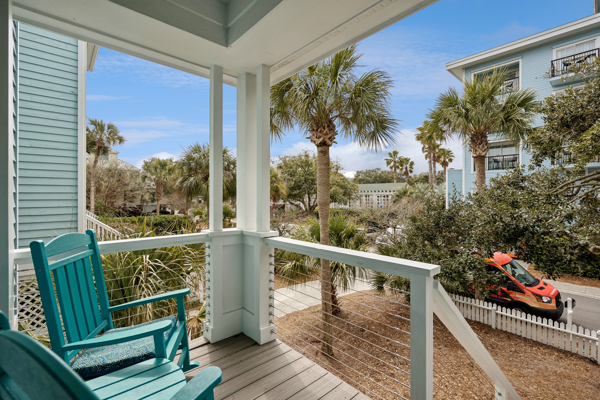 Sip your morning coffee on this peaceful covered balcony, surrounded by swaying palms and tropical coastal charm.