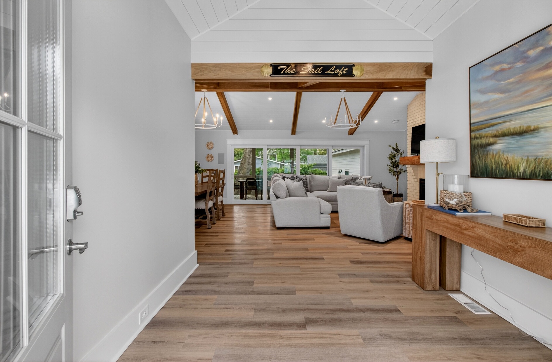 Step into your coastal retreat where rustic beams and soft grays create the perfect harmony for relaxation.