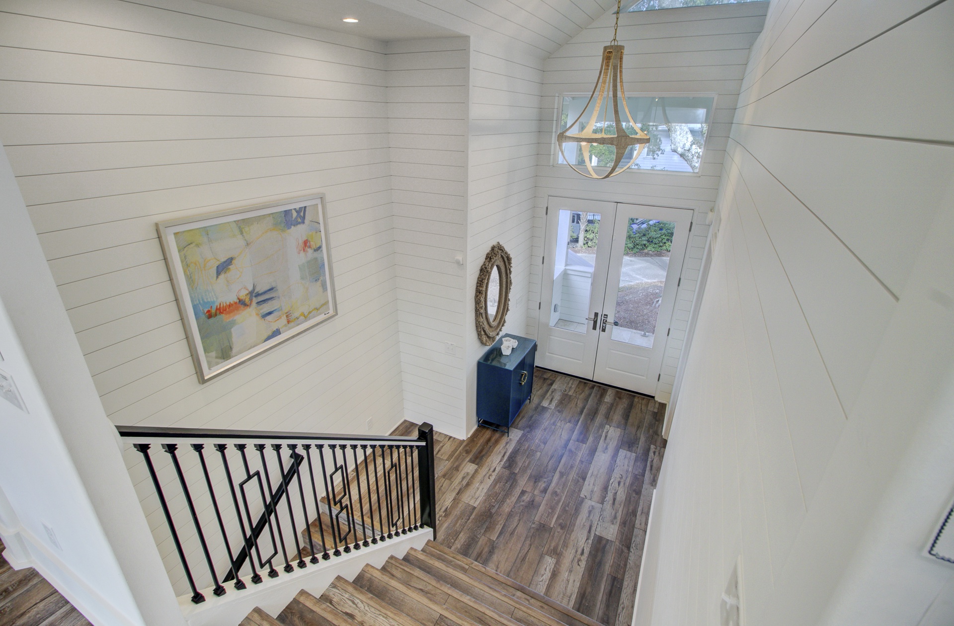 Step into your bright, welcoming entryway where coastal-inspired decor and warm wood floors greet you after a day of exploration.