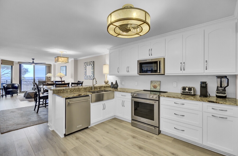 Your modern kitchen flows seamlessly into the bright living space, featuring granite counters and stainless appliances for effortless meal prep.