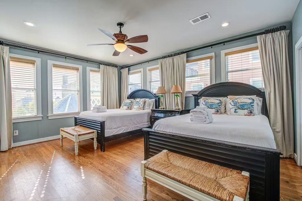 Rest peacefully in your twin-bed retreat with gleaming hardwood floors, ceiling fan comfort, and city views through multiple windows.