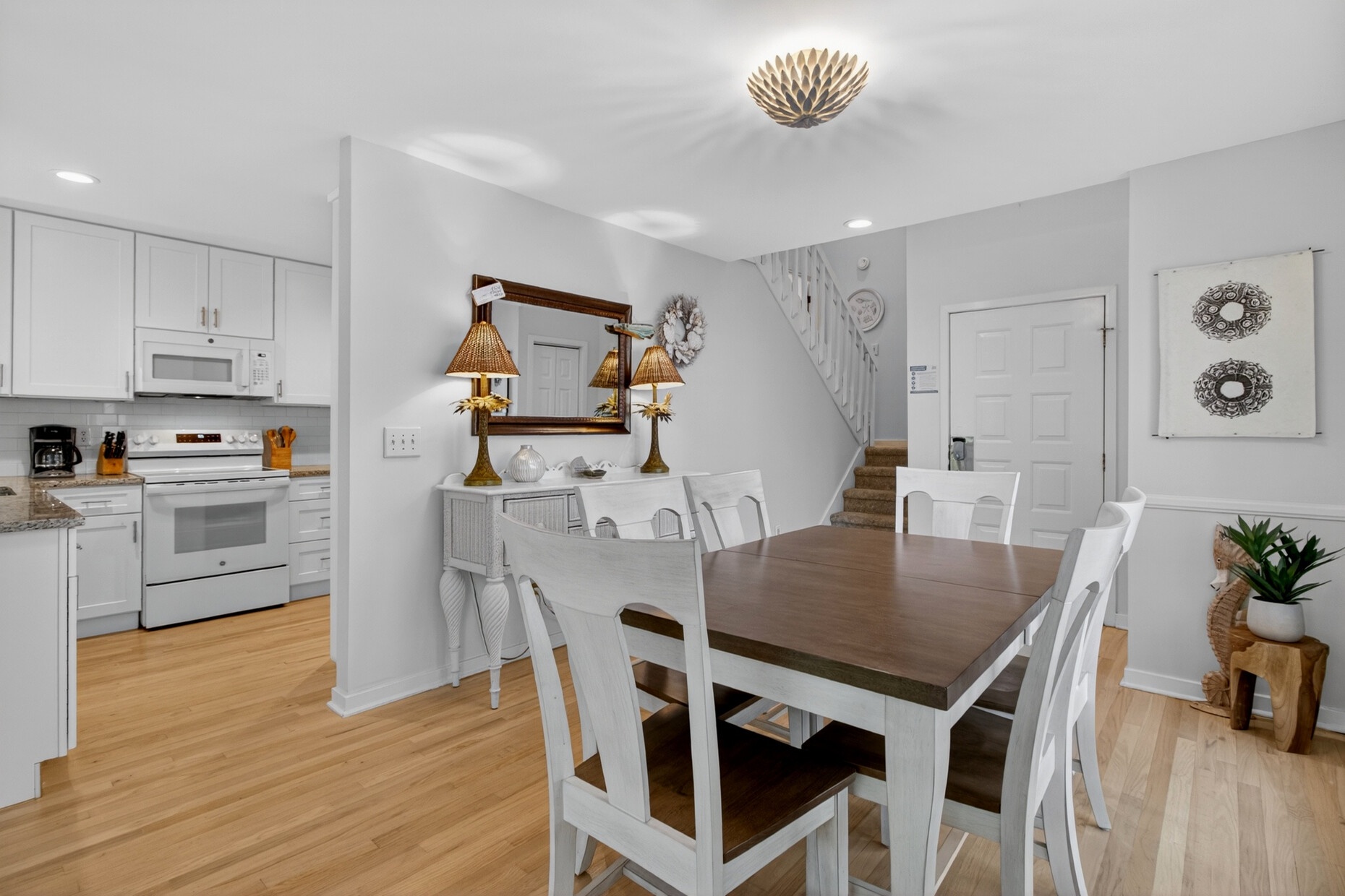 Gather around your spacious dining table for memorable meals, perfectly positioned between the well-equipped kitchen and cozy living spaces.