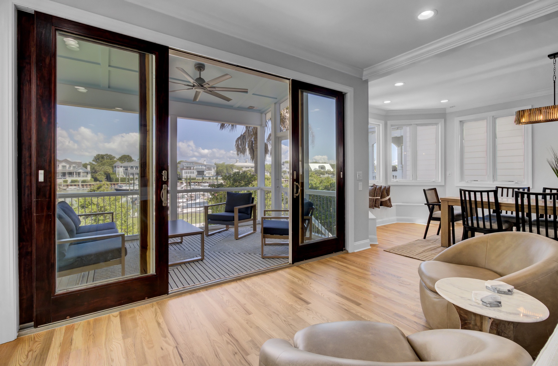Step into your elegant living space where floor-to-ceiling windows frame stunning marina views, creating the perfect backdrop for relaxation.