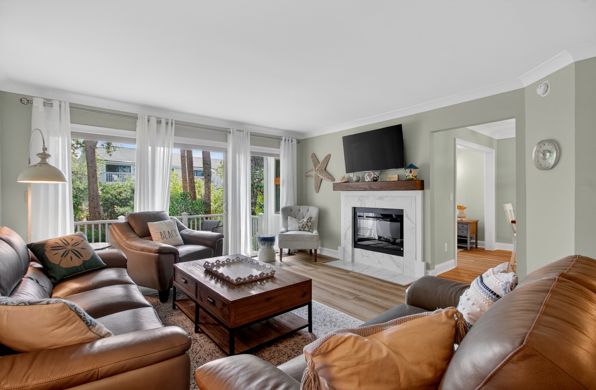 Settle into plush leather sofas by the fireplace, where coastal charm meets modern comfort in your home away from home.