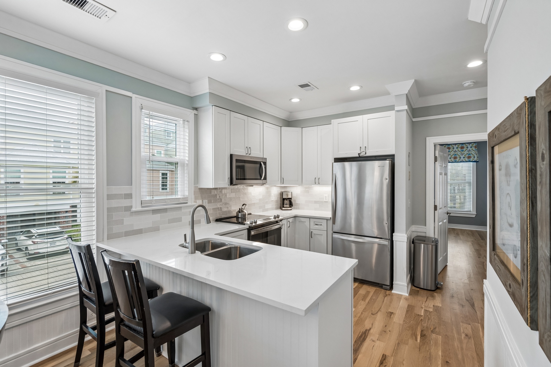 Your fully equipped kitchen awaits with sleek quartz countertops, stainless appliances, and a breakfast bar where you can sip morning coffee.