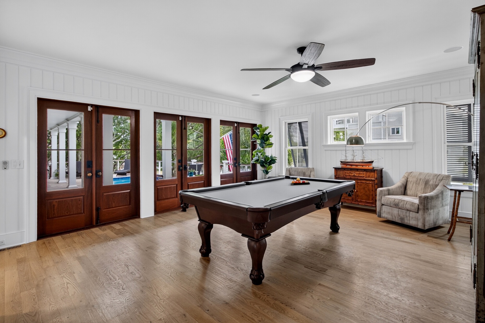 Challenge your travel companions to a friendly game of pool in this elegant game room, where natural light streams through glass doors opening to your private outdoor space.