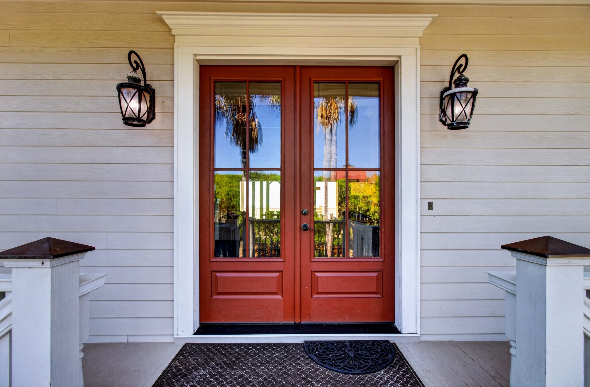 Elegant double doors with tropical views welcome you to your coastal retreat.