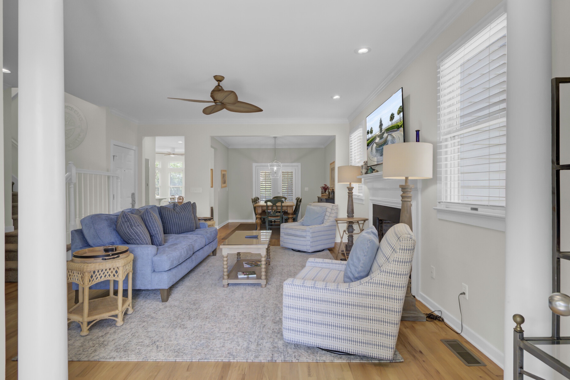 Unwind in your beautifully appointed living space with plush blue seating, warm hardwood floors, and a cozy fireplace for perfect relaxation.