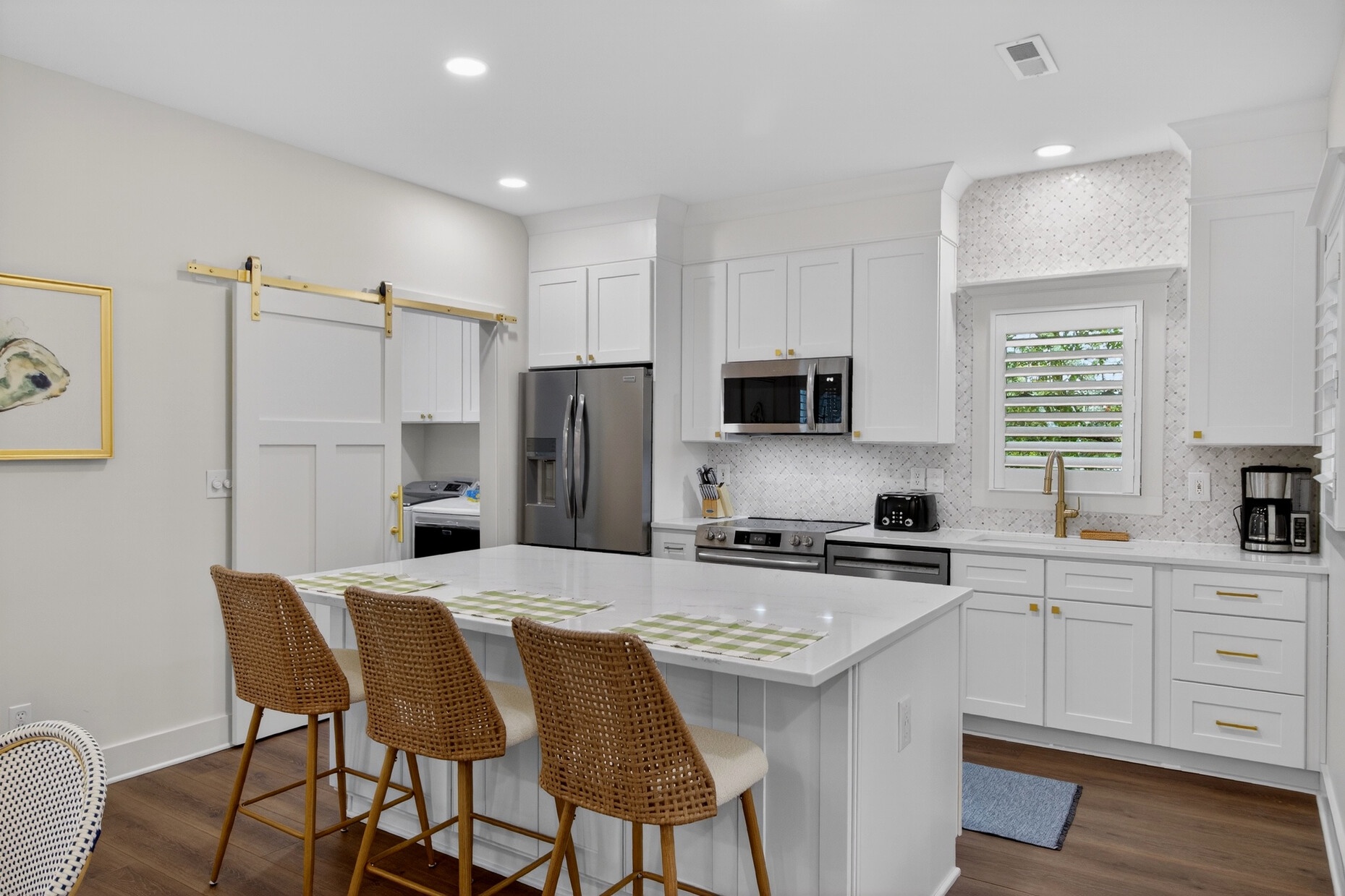 This bright, modern kitchen invites you to cook and gather with its spacious island, premium appliances, and warm coastal touches.