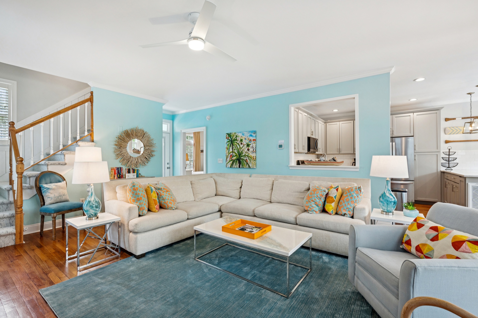 Sink into this stylish sectional where turquoise walls and coastal accents create your perfect seaside retreat atmosphere.