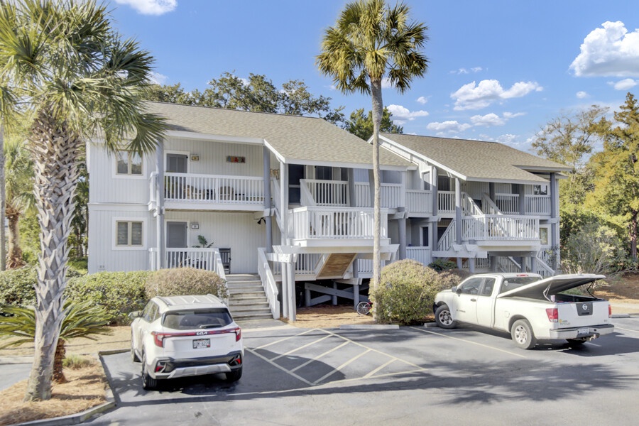 Spacious two-story building nestled among tropical palms with convenient parking spaces right outside your door.