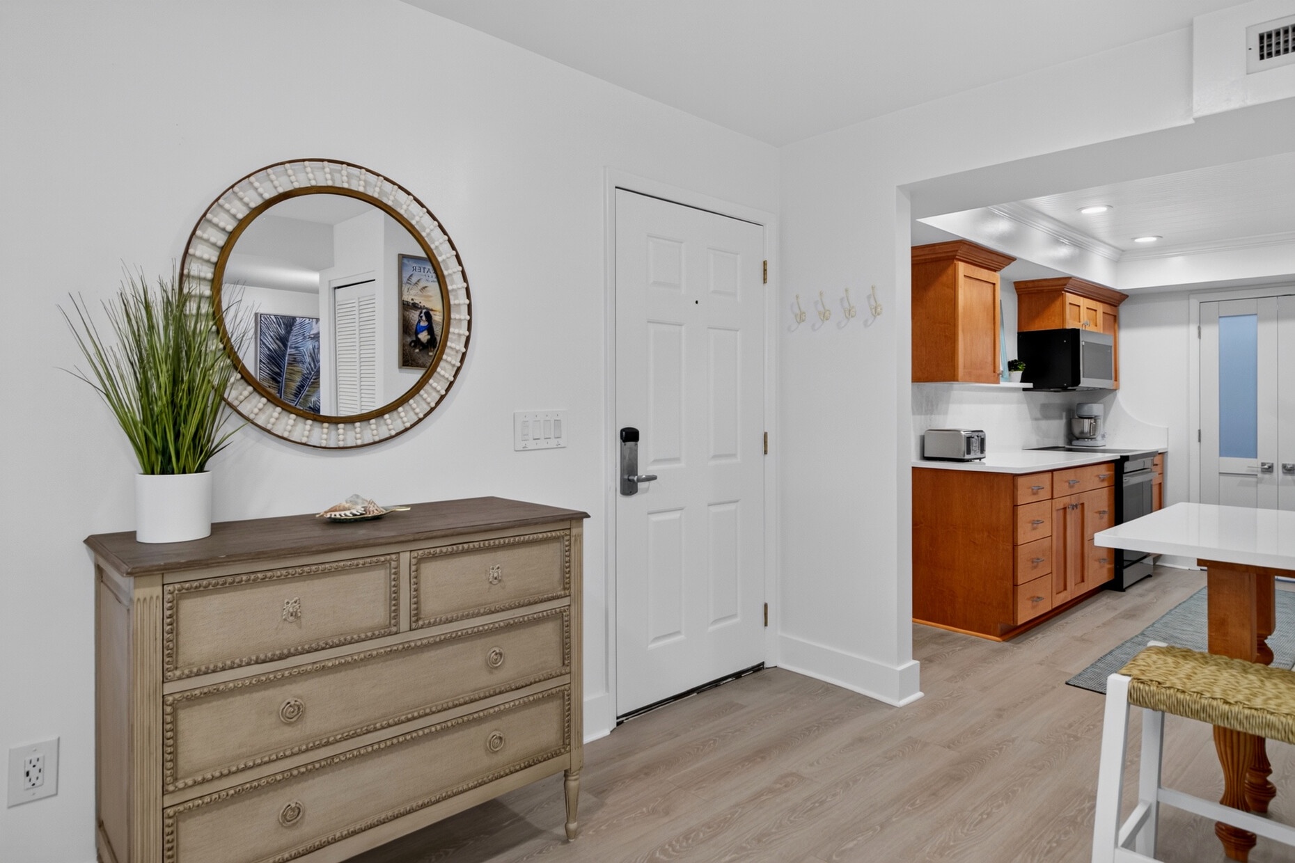 Step into your bright, open living space with coastal touches and a fully equipped kitchen ready for your stay.