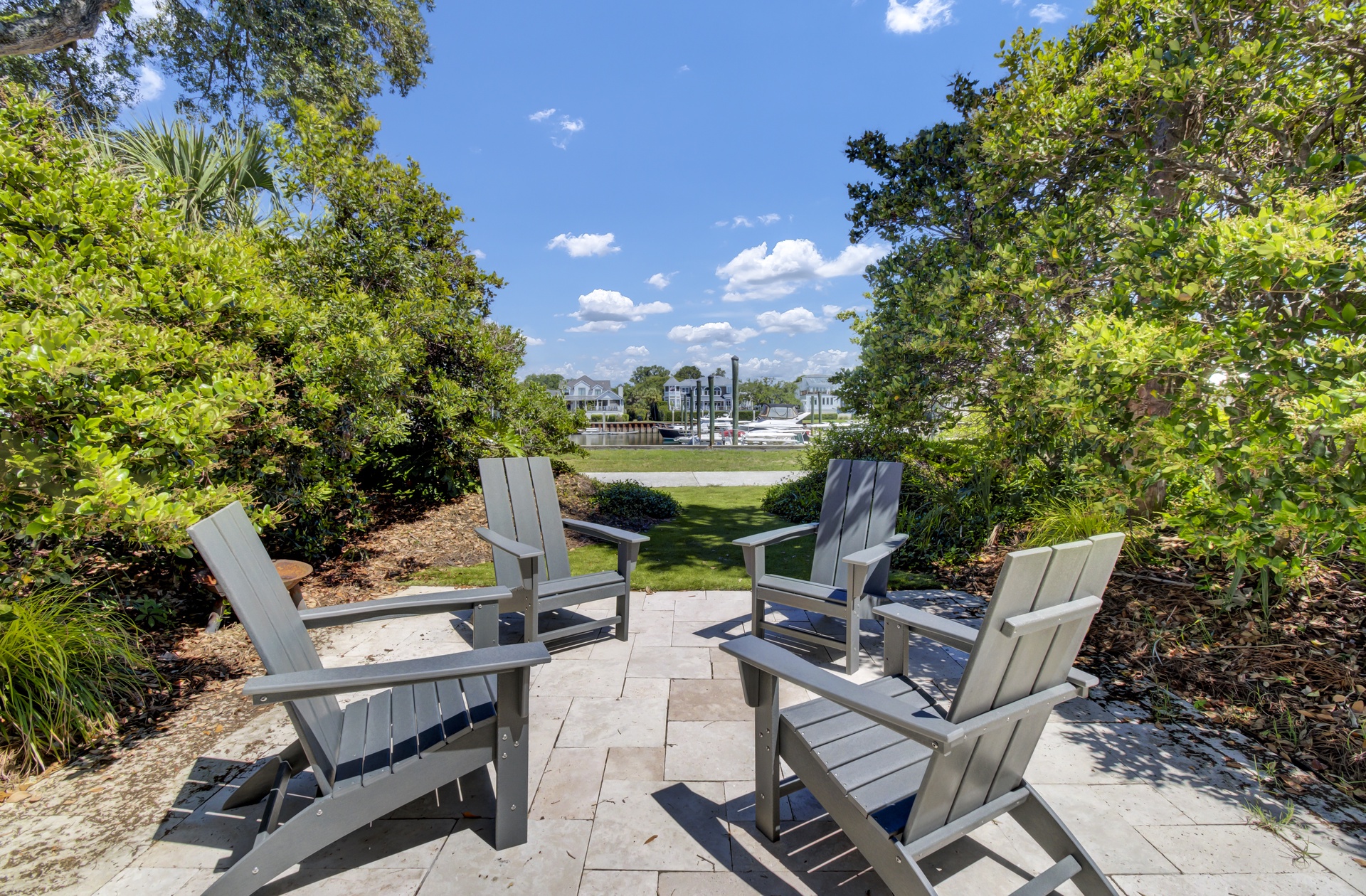 Unwind in this peaceful seating area surrounded by lush landscaping, where comfortable chairs invite you to relax and enjoy tranquil garden views.