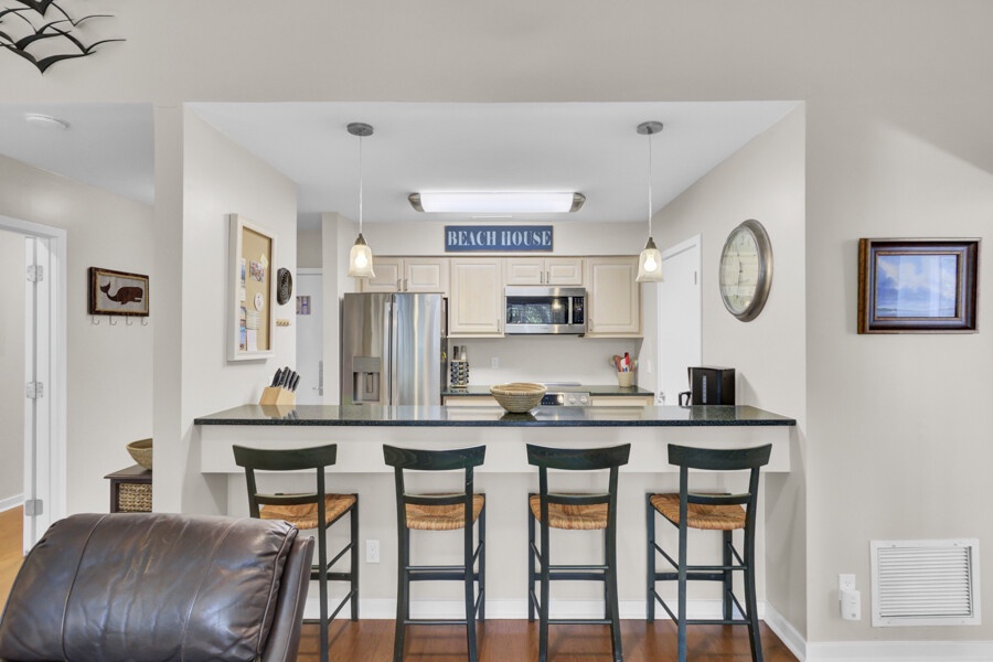Your open-concept kitchen and living space creates the perfect beach house atmosphere with modern appliances and cozy seating for memorable meals together.
