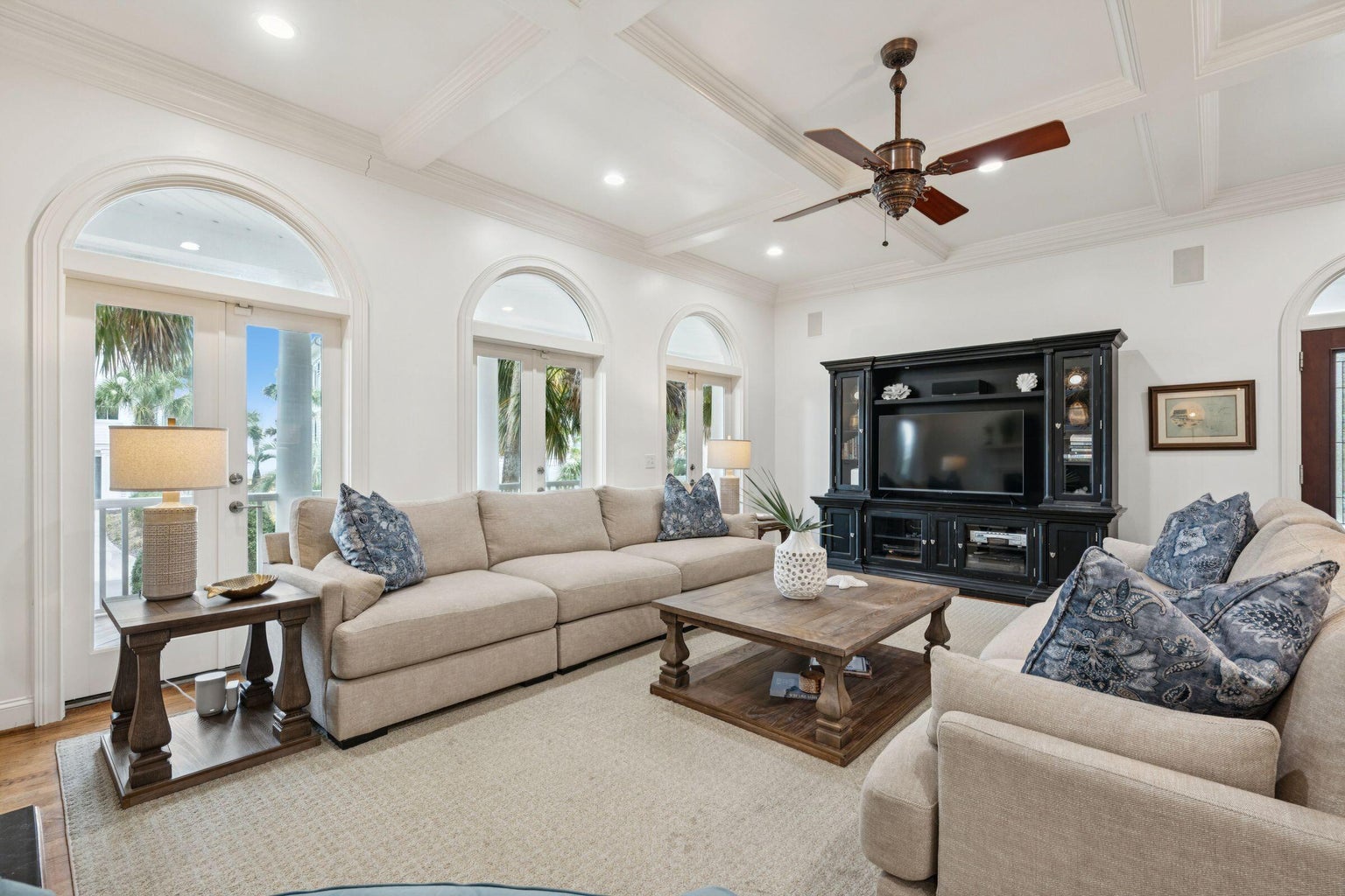 Relax in this elegant living room with plush seating, coffered ceilings, and French doors opening to your private balcony.
