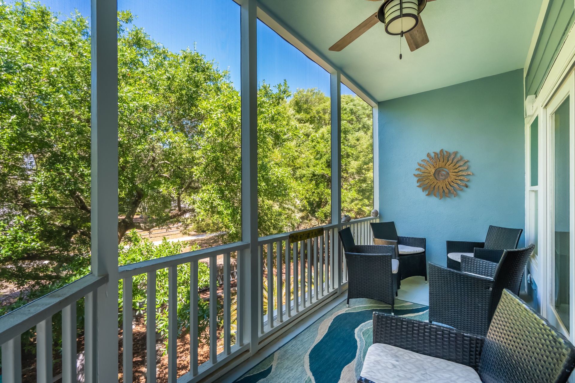 Unwind in your private screened porch with garden views, where a ceiling fan keeps you comfortable and stylish seating invites morning coffee or evening conversation.
