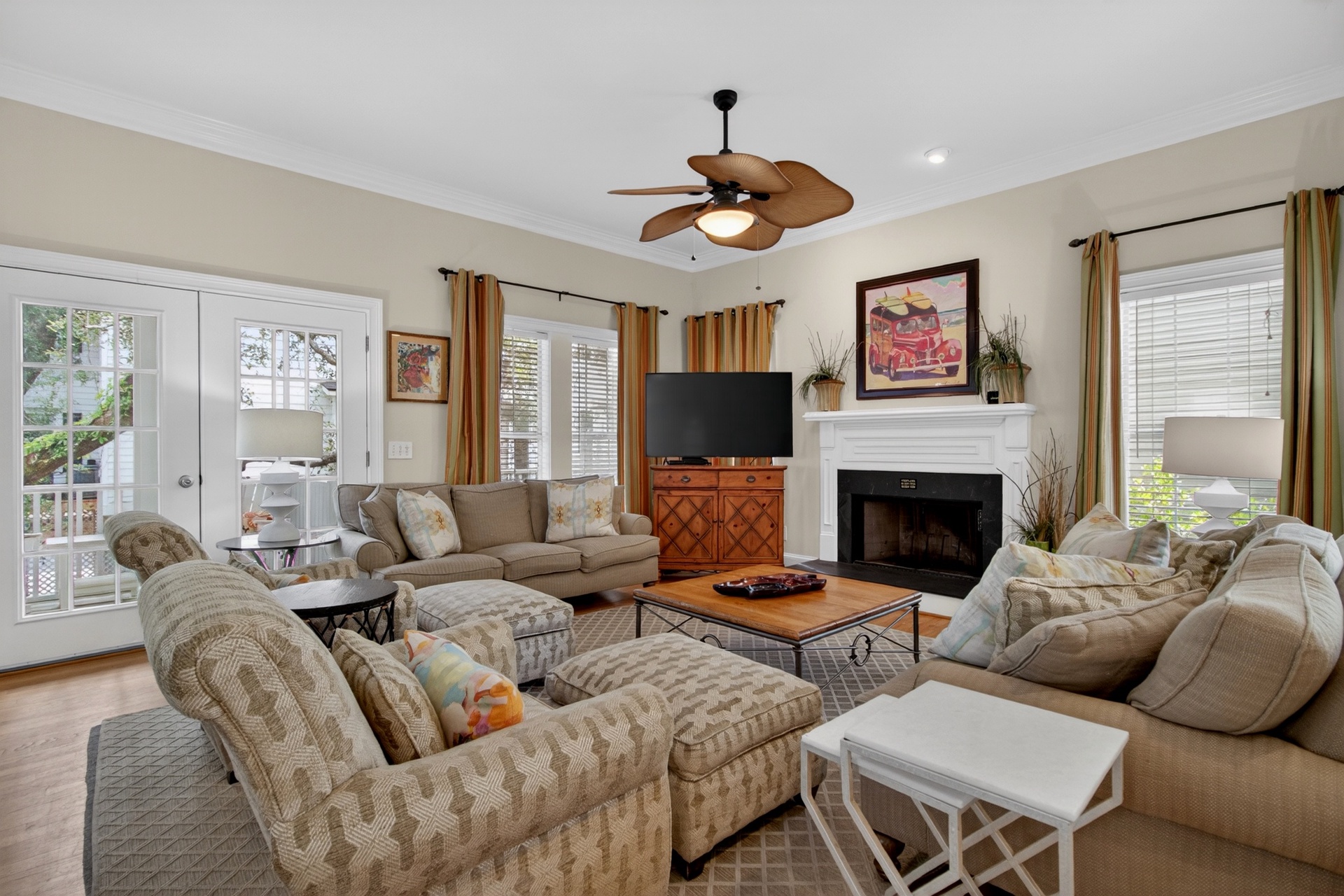 Settle into plush seating in this inviting living room, where you can gather with loved ones by the fireplace or step through French doors to your private deck.